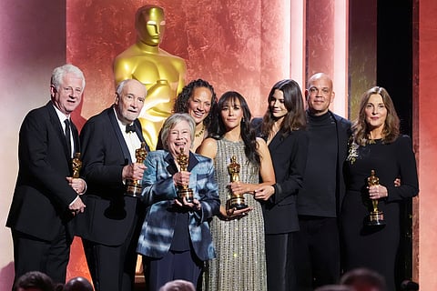 Richard Curtis, from left, Michael G. Wilson, Juliet Taylor, Martina Jones, Rashida Jones, Kenya Kinski-Jones, Quincy Jones III, and Barbara BroccolADi pose with their awards during the 15th Governors Awards on Sunday, Nov. 17, 2024, at The Ray Dolby Ballroom in Los Angeles. 