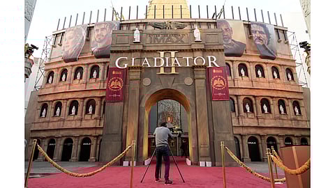 A photographer lines up a picture of the TCL Chinese Theatre, designed to resemble the Roman Coliseum for the premiere of the film 'Gladiator II' on Monday, Nov. 18, 2024, at TCL Chinese Theatre in Los Angeles