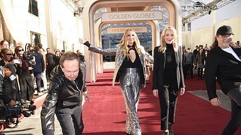 Barry Adelman, from left, Nikki Glaser, Helen Hoehne, and Glenn Weiss roll out the red carpet during the 82nd Golden Globes press preview on Thursday