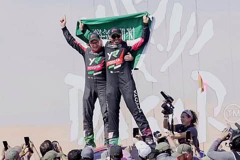 Driver Yazeed Al Rajhi, of Saudi Arabia, right, and co-driver Timo Gottschalk, of Germany celebrate winning the Dakar Rally after the twelfth stage in Shubaytah, Saudi Arabia, Friday, Jan. 17, 2025
