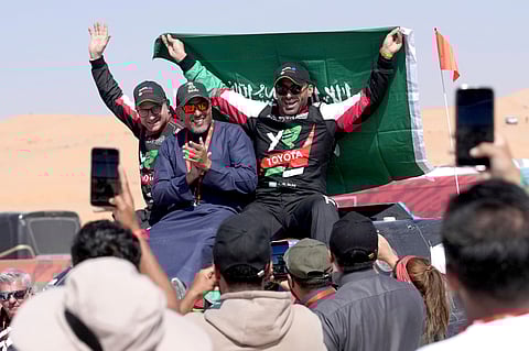 Driver Yazeed Al Rajhi, of Saudi Arabia, right, and co-driver Timo Gottschalk, of Germany celebrate winning the Dakar Rally after the twelfth stage  in Shubaytah, Saudi Arabia, Friday, Jan. 17, 2025.