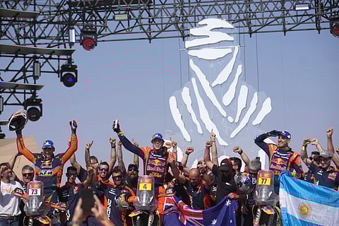 Rider Daniel Sanders of Australia, centre, celebrates winning the Dakar Rally after the twelfth stage in Shubaytah, Saudi Arabia, Friday, Jan. 17, 2025.