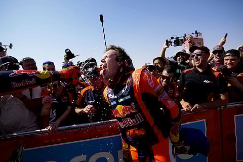 Rider Daniel Sanders of Australia celebrates winning the Dakar Rally after the twelfth stage in Shubaytah, Saudi Arabia, Friday, Jan. 17, 2025.