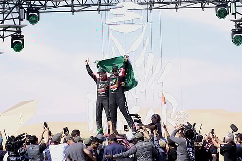 Driver Yazeed Al Rajhi, of Saudi Arabia, right, and co-driver Timo Gottschalk, of Germany celebrate winning the Dakar Rally after the twelfth stage in Shubaytah, Saudi Arabia, Friday, Jan. 17, 2025.