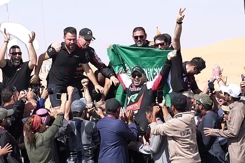 Driver Yazeed Al Rajhi, of Saudi Arabia, center, celebrates winning the Dakar Rally after the twelfth stage in Shubaytah, Saudi Arabia, Friday, Jan. 17, 2025.