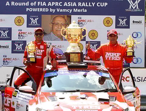 Karna Kadur (left) and co-driver Musa Sherif with the Indu Chandhok Memorial South India Rally Overall winner trophy