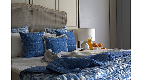 Blue Hues quilt styled on a bed with earthy décor and soft natural lighting