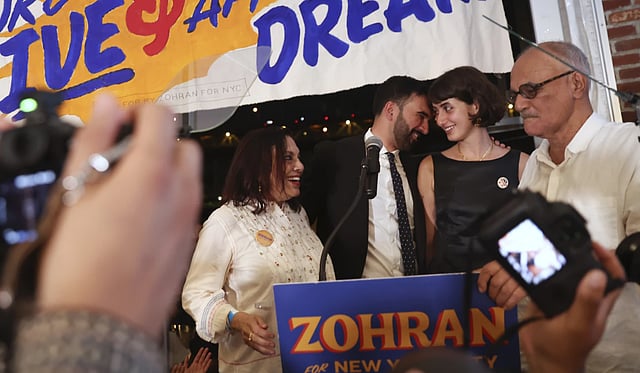 Zohran Mamdani, center right, on stage with his family including his mother, Mira Nair, left, his wife, Rama Duwaji, and father, Mahmood Mamdani, right, at his primary election party in NYC
