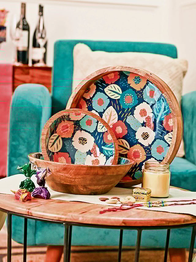 Set of wooden trays featuring delicate painted designs inspired by spring.