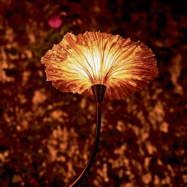 Handcrafted botanical-themed floor lamp emitting warm, diffused light through textured natural materials