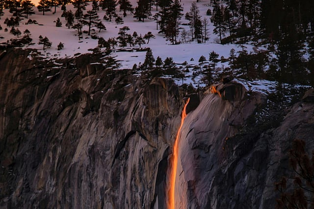 At Yosemite National Park in California, sunlight reflects off the flowing water, creating a breathtaking firefall illusion. Firefall at Yosemite National Park