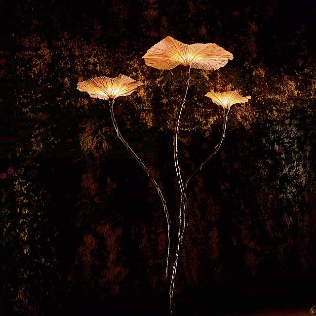 Sustainable lighting sculpture inspired by water lilies, featuring delicate paper leaves on graceful stalks