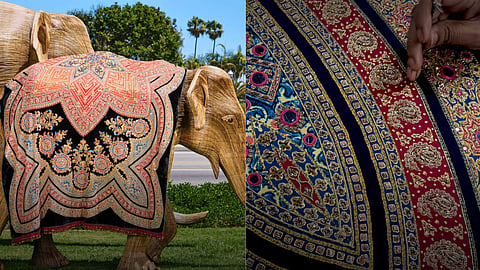 Life-sized elephant sculpture draped in a hand-embroidered ceremonial blanket created by artisans.
