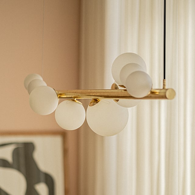 Kellan Chandelier by Orange Tree with elegant curved glass orbs and minimalist metal framework, capturing the gentle motion and glow of the moon.