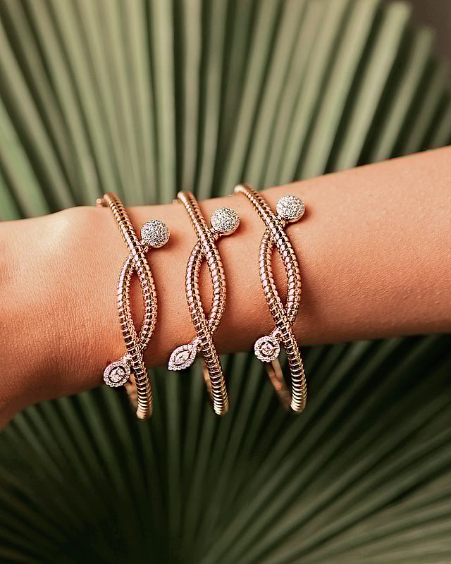 Detailed view of hand-finished gold bangles
