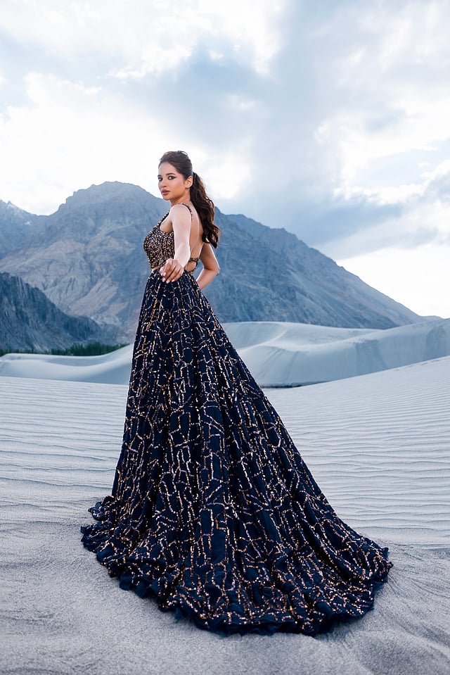 Model walking in a sleek fishcut gown with 3D embroidered accents