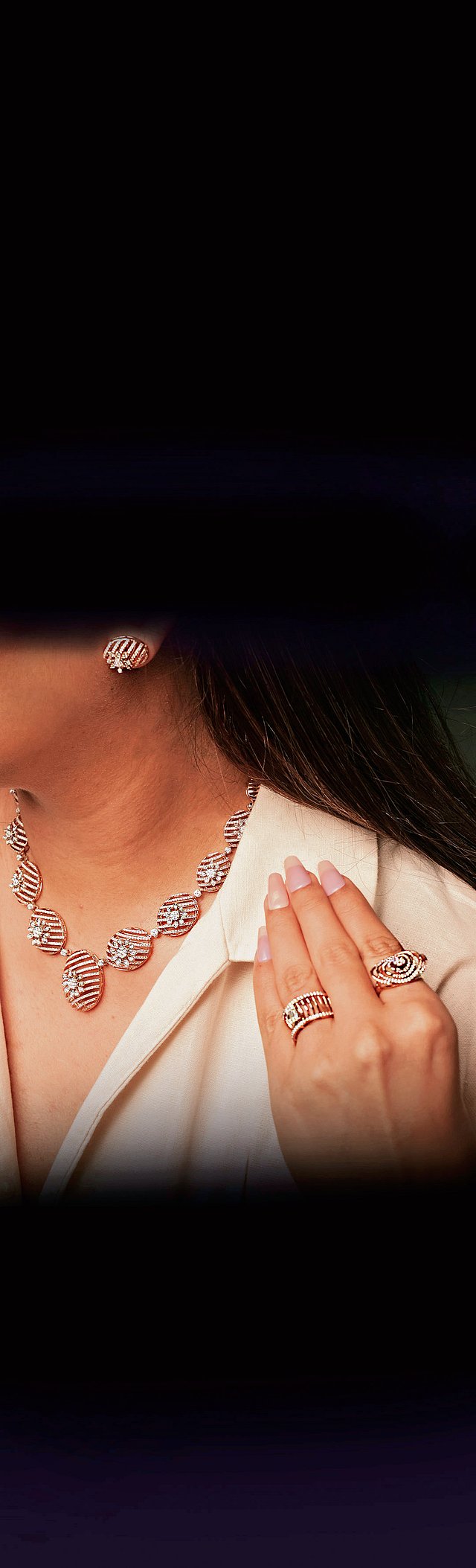 Detailed view of hand-finished gold jewellery with a liquid shine effect