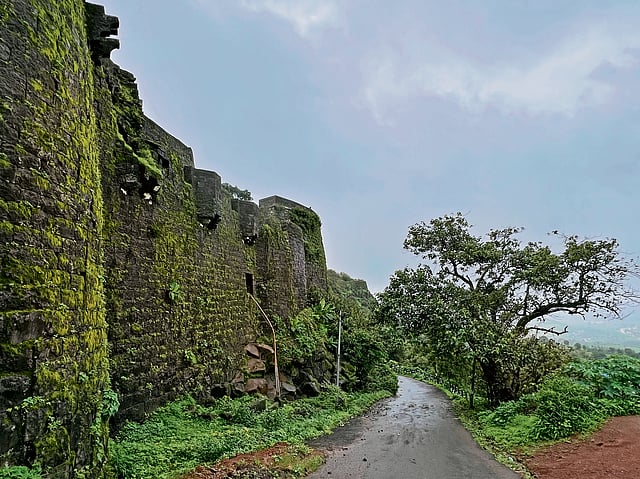 Scenic monsoon drive to Panhala Fort with misty hills and lush greenery in Kolhapur