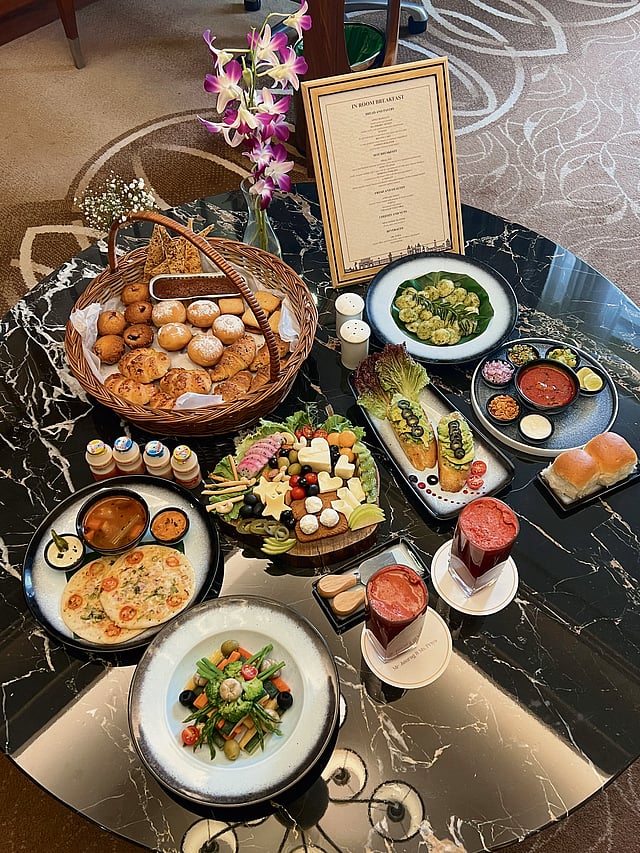 Luxury breakfast in bed served at Sayaji Hotel, Kolhapur with fresh fruits, pastries, and coffee