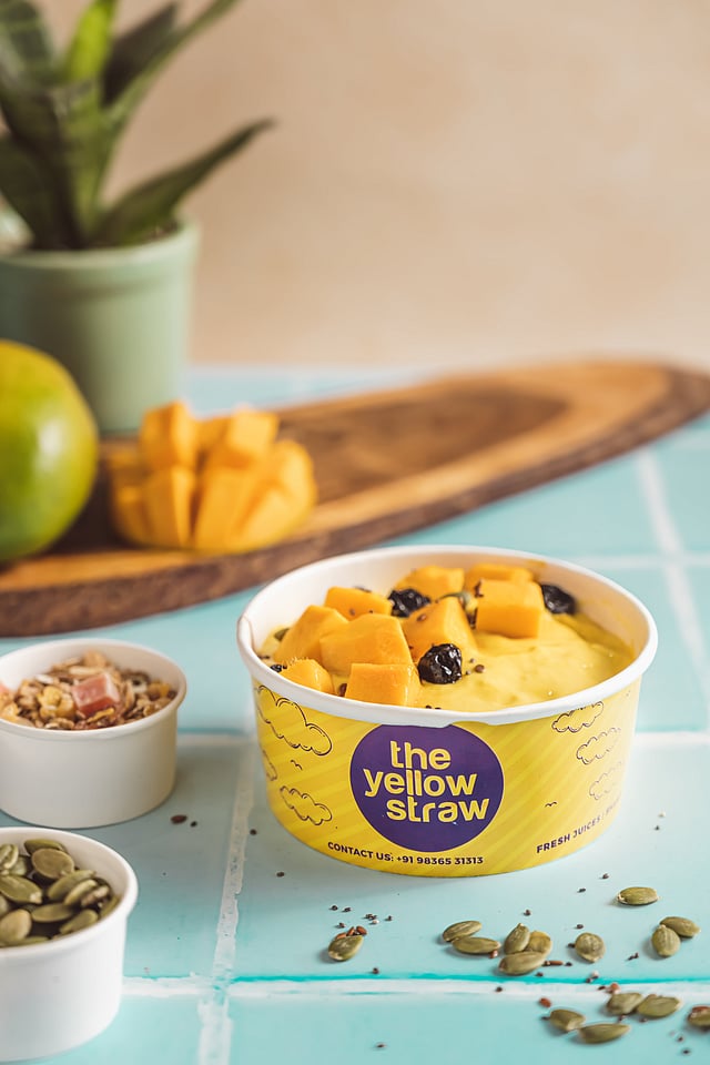A creamy King Mango Smoothie Bowl boasted of smoothie, fresh fruits, granola and seeds