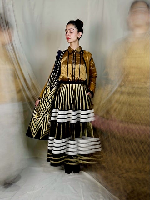 Sunhera introduces metallic touches of gold, silver, and bronze to Ka-Sha’s signature black and white applique designs