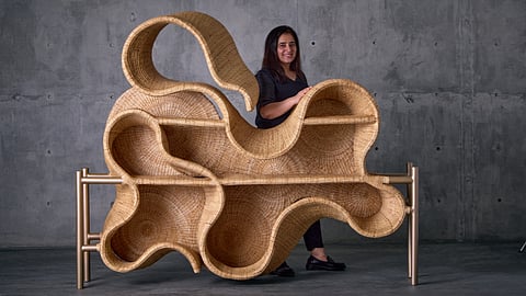 Sculptural outdoor daybed with weather-proof cushions and a removable canopy for shade.