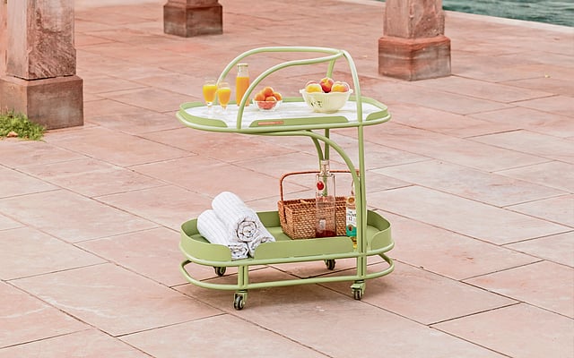 Minimalist outdoor bar table with mosaic tiled top.