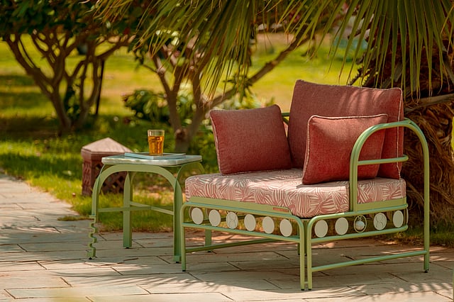 Modern outdoor seating inspired by traditional craftsmanship with sage green framework and sculptural silhouettes.