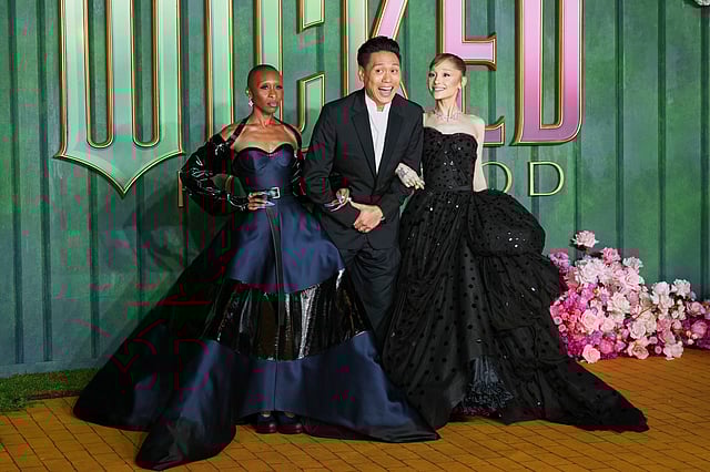 Cynthia Erivo, director Jon M. Chu and Ariana Grande pose for photographers upon arrival at the premiere of the film Wicked For Good in London
