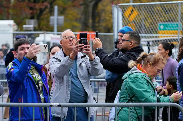 People take photos of Buzz Lightyear balloon during the preparations for the 99th Macy's Thanksgiving Day Parade Wednesday, Nov. 26, 2025, in New York