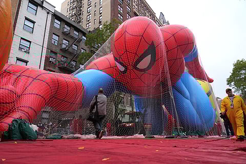 Volunteers pass a Spider-Man balloon during preparations for the 99th Macy's Thanksgiving Day Parade Wednesday, Nov. 26, 2025, in New York
