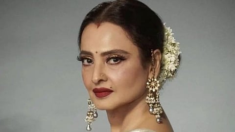 Rekha pushes a fan away at Mumbai airport