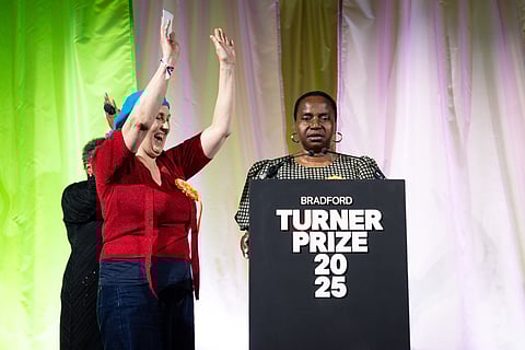 Nnena Kalu, right, is announced as the winner of the Turner Prize 2025 at a ceremony at Bradford Grammar School, in Bradford, England