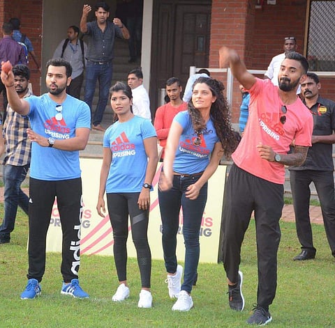 Saiyami tries bowling along with cricketer KL Rahul (extreme right)