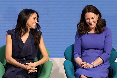 Meghan Markle in a Jason Wu wrap dress, with Kate Middleton