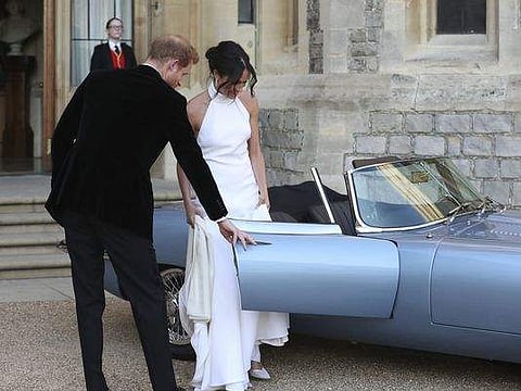 Prince Harry and his wife, Meghan Markle leave for the reception.