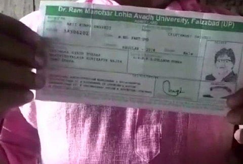 The admit card with the picture of Amitabh Bachchan on it.