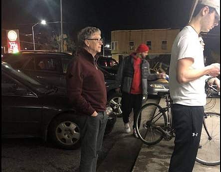 The picture of Bill Gates standing in the line