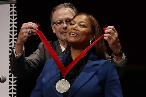 Queen Latifah receives the W.E.B. Dubois Medal for her contributions to black history and culture from Glenn H Hutchins at Harvard University, in Cambridge, Mass. (AP Photo/Elise Amendola)