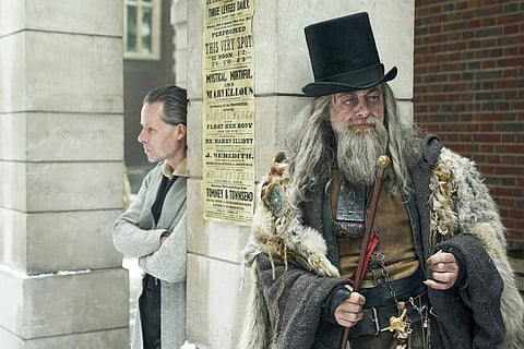 Guy Pearce as Ebenezer Scrooge and Andy Serkis as the Spirit of Christmas Past in A Christmas Carol (Robert Viglasky/FX Networks via AP)