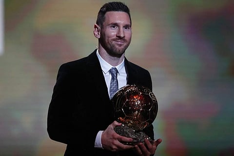 Barcelona's soccer player Lionel Messi holds the trophy of the Golden Ball award ceremony in Paris, Monday, Dec. 2, 2019.(AP)