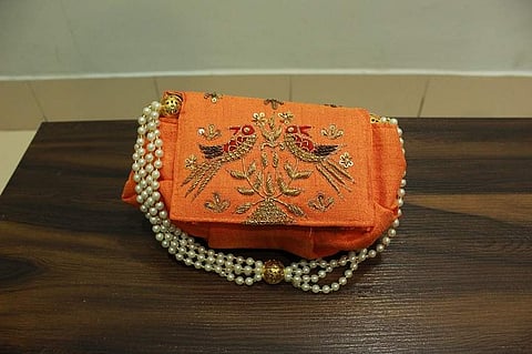 A bejewelled clutch at Imara Couture