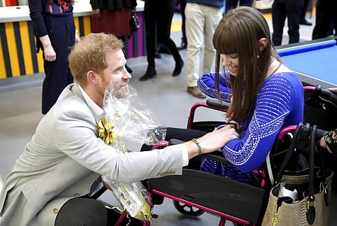Wellwishers welcome Britain's Prince Harry as he arrives for the official opening of 'Future', a new Youth Zone in London, Thursday April 11, 2019. (Chris Jackson/PA via AP)