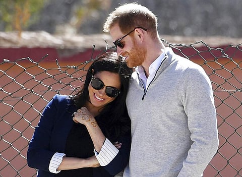 Prince Harry and Meghan watch children playing football at a school in the town of Asni, in the Atlas mountains, Morocco on Feb 24, 2019. (Facundo Arrizabalaga/Pool via AP)