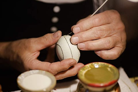 A woman decorates an Easter egg with wax at a traditional Easter Market of Germany's Sorb minority in the village Neuwiese, near the city of Hoyerswerda in east Germany. (AP Photo/Markus Schreiber)