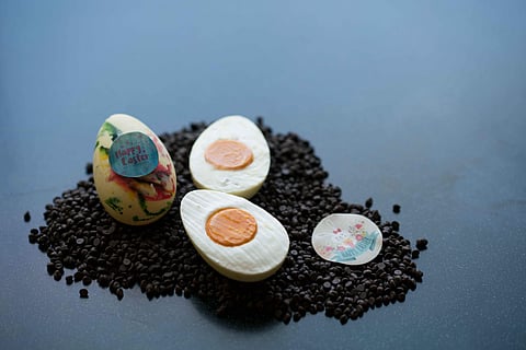 White chocolate eggs stuffed with coconut cream and mango-passion fruit ganache