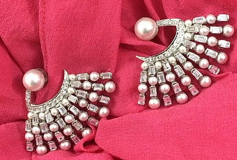 A Nive earring made with faux pearls