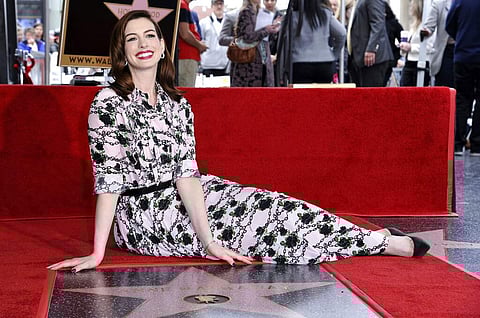 Actress Anne Hathaway poses atop her new star on the Hollywood Walk of Fame following a ceremony in her honour on Thursday, May 9, 2019, in Los Angeles. (Photo by Richard Shotwell/Invision/AP)