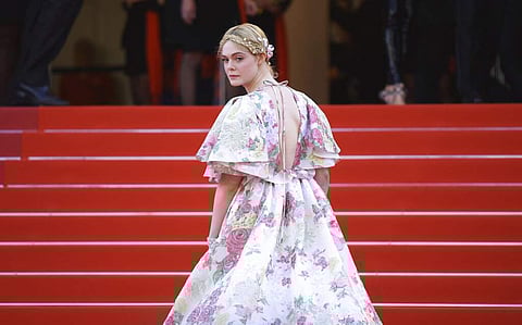 Jury member Elle Fanning poses for photographers upon arrival at the premiere of the film 'Les Miserables' at the 72nd international film festival
