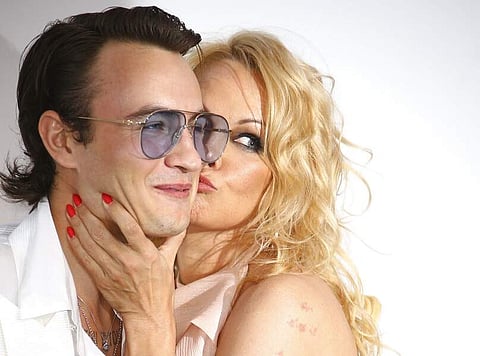 Actress Pamela Anderson kisses her son Brandon Thomas Lee at the amfAR, Cinema Against AIDS, benefit at the Hotel du Cap-Eden-Roc, at the 72nd Cannes film festival. (Photo by Joel C Ryan/Invision/AP)